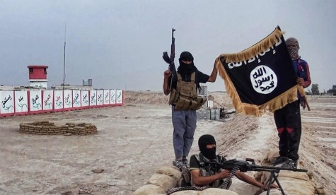 ISIS members hold up a militant flag. Photo courtesy of NBC News.