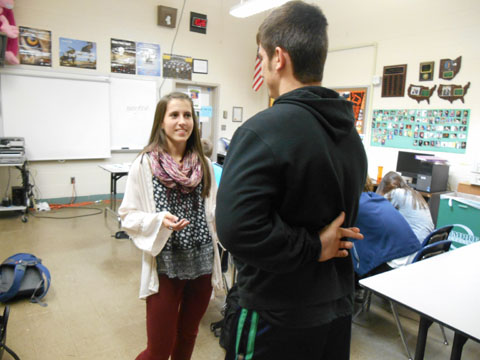 Junior Tyler Liddy crosses fingers as he lies to his friend, junior Rachael Leiter.