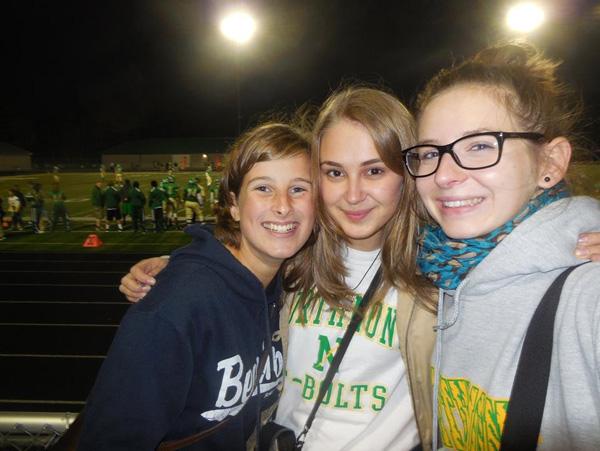 Exchange students Franzi and Emma from Germany huddle with Sia from Ukraine. 