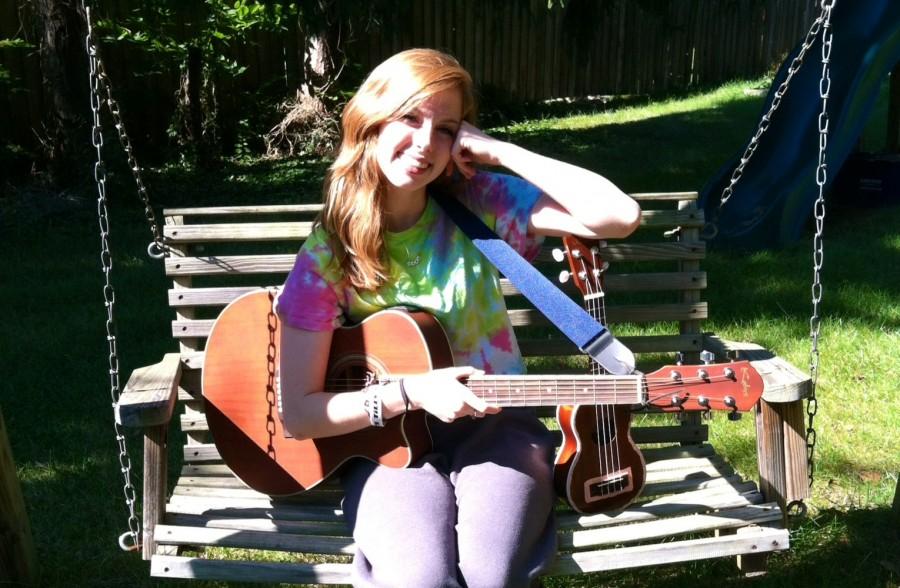 Pictured above, senior Gab Schuh holds her acoustic guitar and ukulele. 