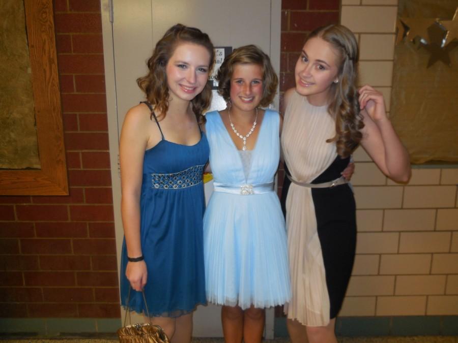 German exchange students Franzi Schutze and Emma Grunmuller stand with Ukranian exchange student Sia Skoryk at their first Homecoming Dance. Schutze and Grunmuller bought their Homecoming dresses in Dayton, while Skoryk brought her dress with her after buying it in Italy. 