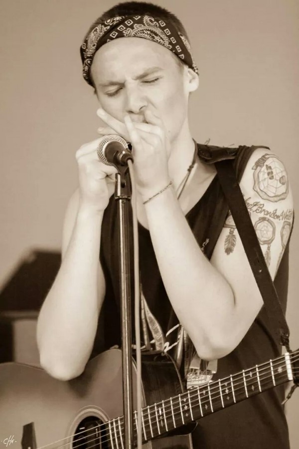 Joe Waters performs on the harmonica.