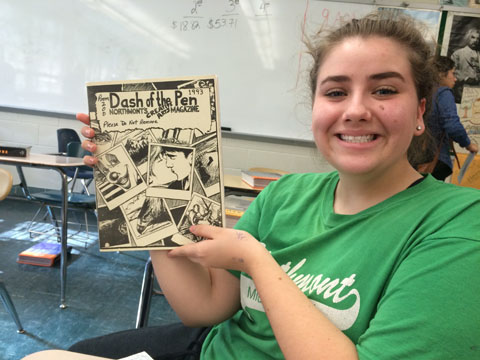 Dash of the Pen editor junior Maggie Laing holds a 1993 issue.
