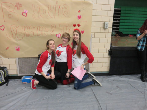 Seniors Eva Stebel and Tori Amos and freshman Cecelia Stebel take a break to work on the poster