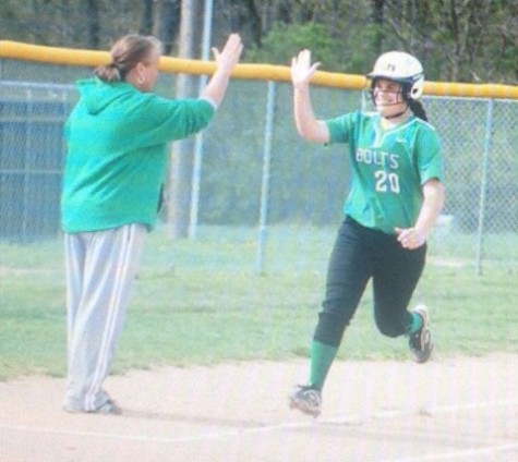 Junior Lizzie Ritchie gives coach Mangen a high five as she rounds third base. Photo courtesy of: Northmont Yearbook