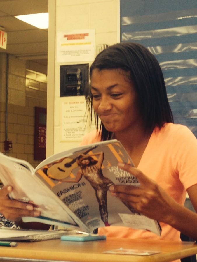 Sophomore Brianna Howard looks at the pages of Elle magazine, which was recently under the microscope for using an unhealthily thin” model in an ad campaign, according to a CNN report in June.