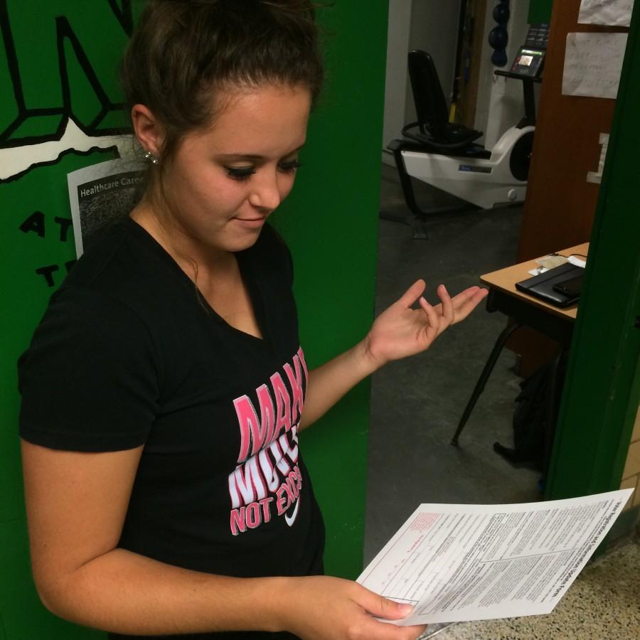Senior Emily Menker expresses confusion while looking over an Ohio voter registration form.
