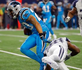 Panthers safety Kurt Coleman breaks a tackle before scoring on an interception return early in the first quarter the Panthers Thanksgiving win (picture and caption from The Associated Press).