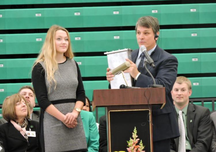 School Board Student Representative senior Samantha Johnson and principal George Caras present the time capsule at the dedication of the new high school building on January 10, 2016.