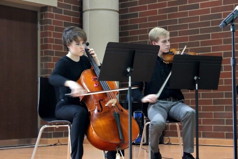 Orchestra members senior Anna Drew and Robbie Spilker perform at the dedication.