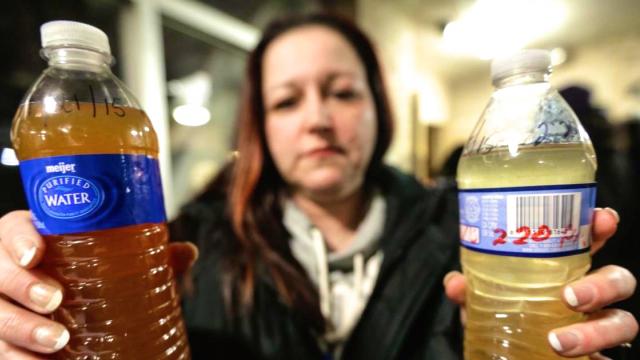 Flint resident holds bottles filled with water from the contaminated source. Courtesy of Google Images.