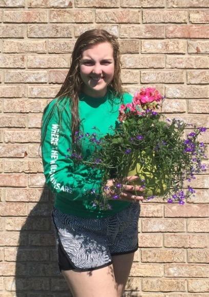 Sophomore Maddie Jaehnen holds flowers at Englewood Florist, her place of work for the summer.