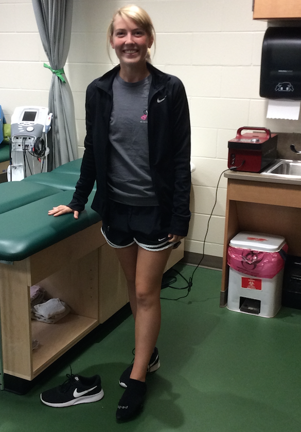 Freshman Ellie Coppock visits the training room to roll out her foot so she can continue running.
