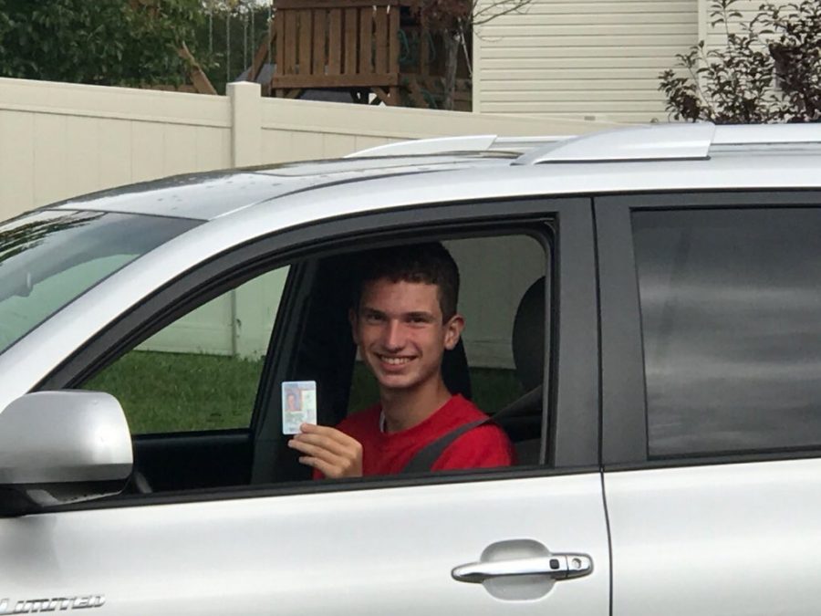 Haker in his car with his license (courtesy of Drew Haker).