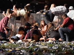 People take cover at the concert as the shots begin (courtesy of CNN).