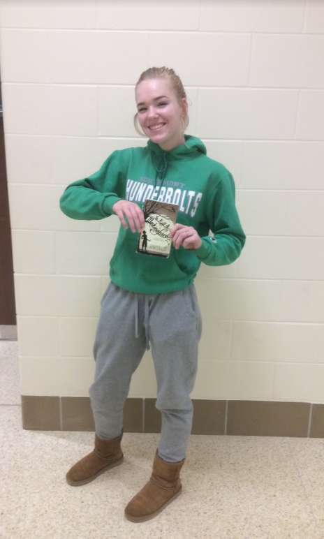 Freshman (first-year) Lizzy Salata holds Harper Lees book To Kill a Mockingbird, which she read last year.