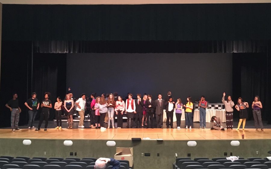 The cast of The Wedding Singer lining up for mic check on the stage.  