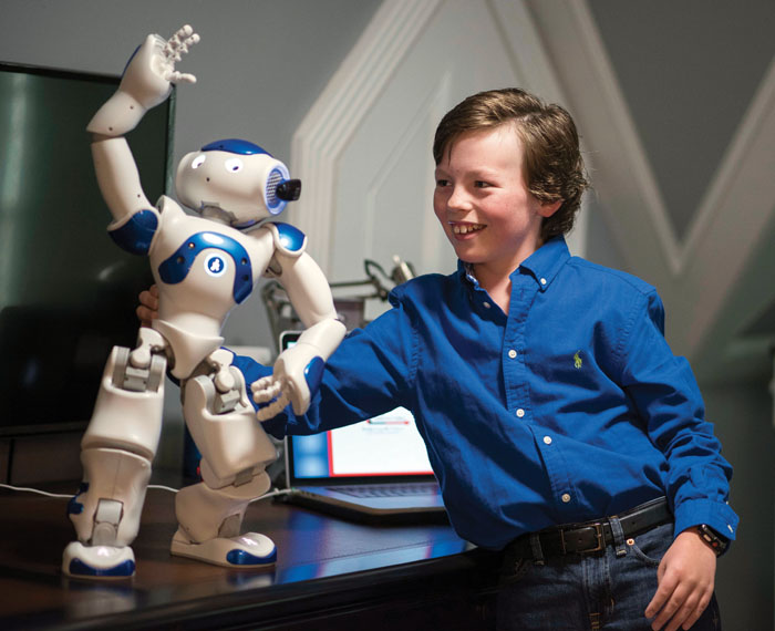 JON C. LAKEY / SALISBURY POST Mike Wimmer helps his Nap Robot Infinite stay balanced as it performs a programmed version of the Thiller dance.  Wimmer, 10-year-old Mensan from Salisbury, recently started his high school career at a CFA Academy in Concord. Wimmer was given the opportunity to give a presentation this past summer at the American Mensa Summer Gathering in Indianapolis with his Nao Robot that he programed for the presentation. .  Salisbury, North Carolina. 10/24/18