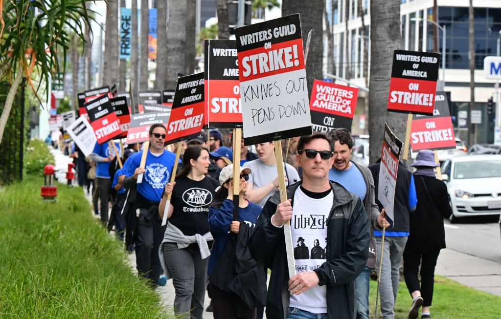 Members of the WGA protesting unfair pay for Writers.  Credit to Getty Images.