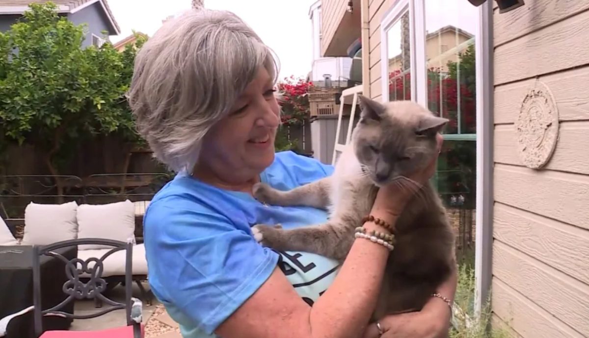 Susanne Anguiano holding her cat, Rayne Beau.