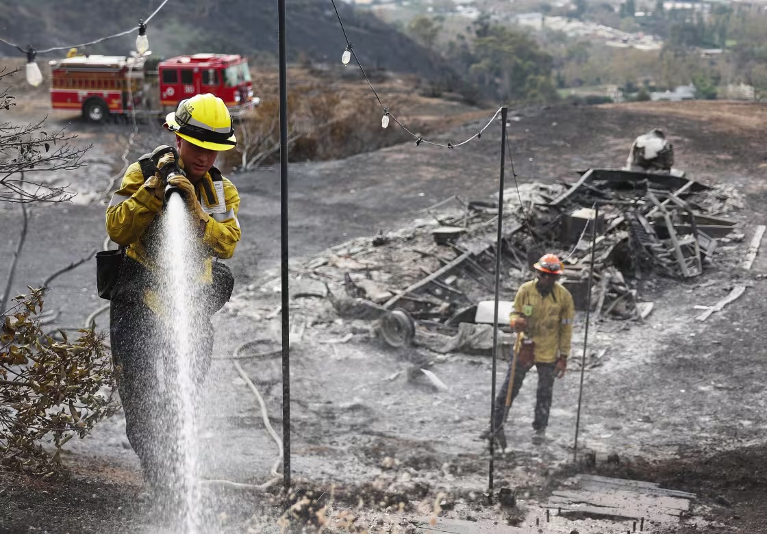 Firefighters work to put out hot spots.