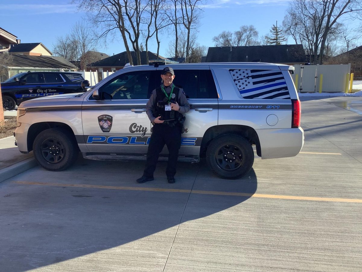 Officer Langenkamp in front of his cruiser 