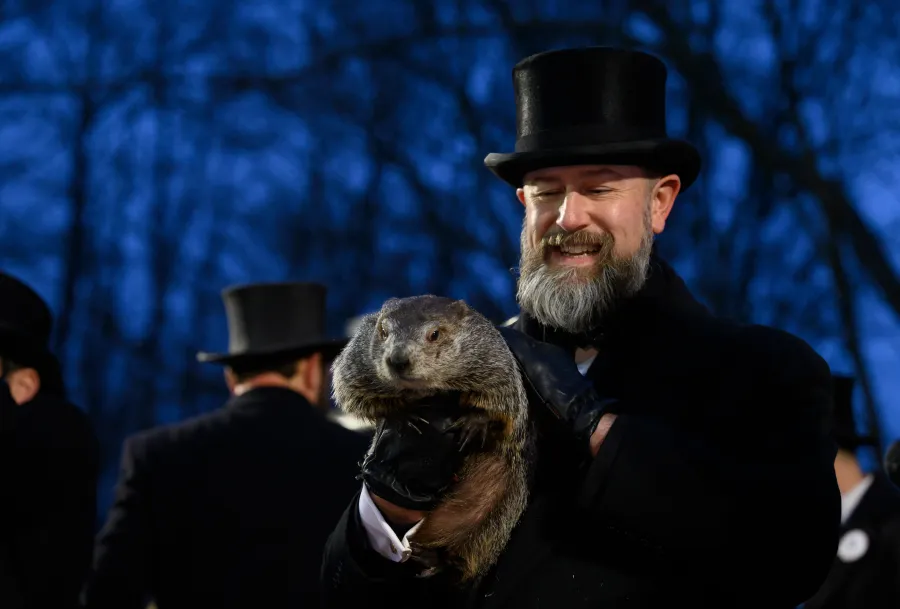 Photo of Phil Punxsutawney being held by a Groundhogs Day Club member.