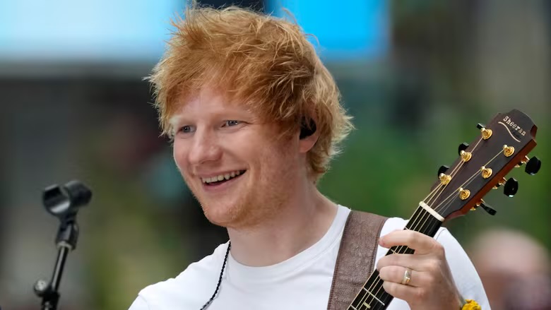 Ed Sheeran performing on a street in Bengaluru, India, when the performance was cut short by a police officer. ( February, 10, 25 | Charles Sykes / Invision / The Associated Press ).