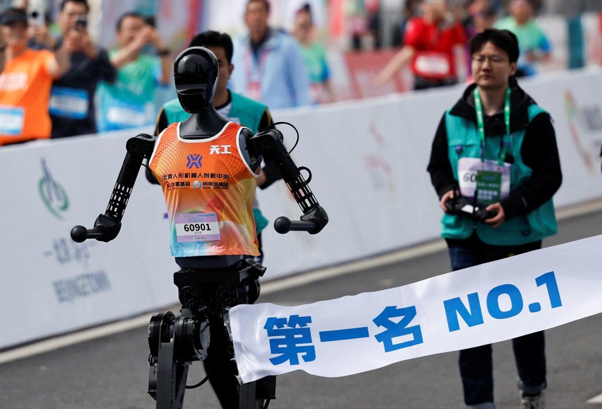 Humanoid running alongside contestants