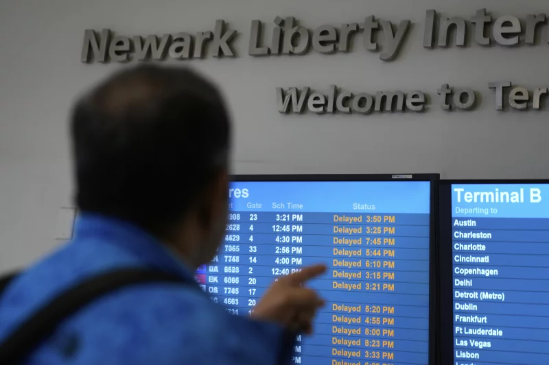 A display board showing all of the delayed flights at Newark Liberty International Airport