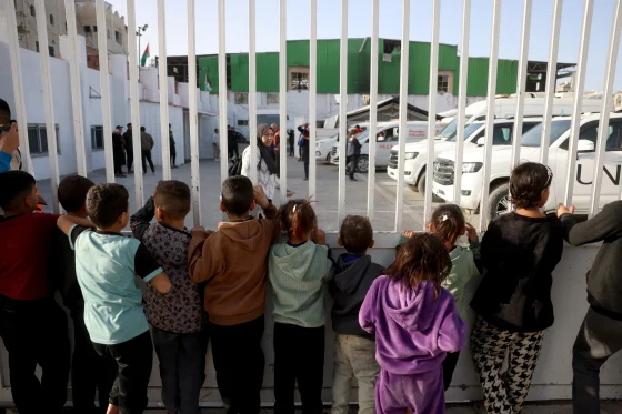Palestinian children watch wounded patients cross through Rafah